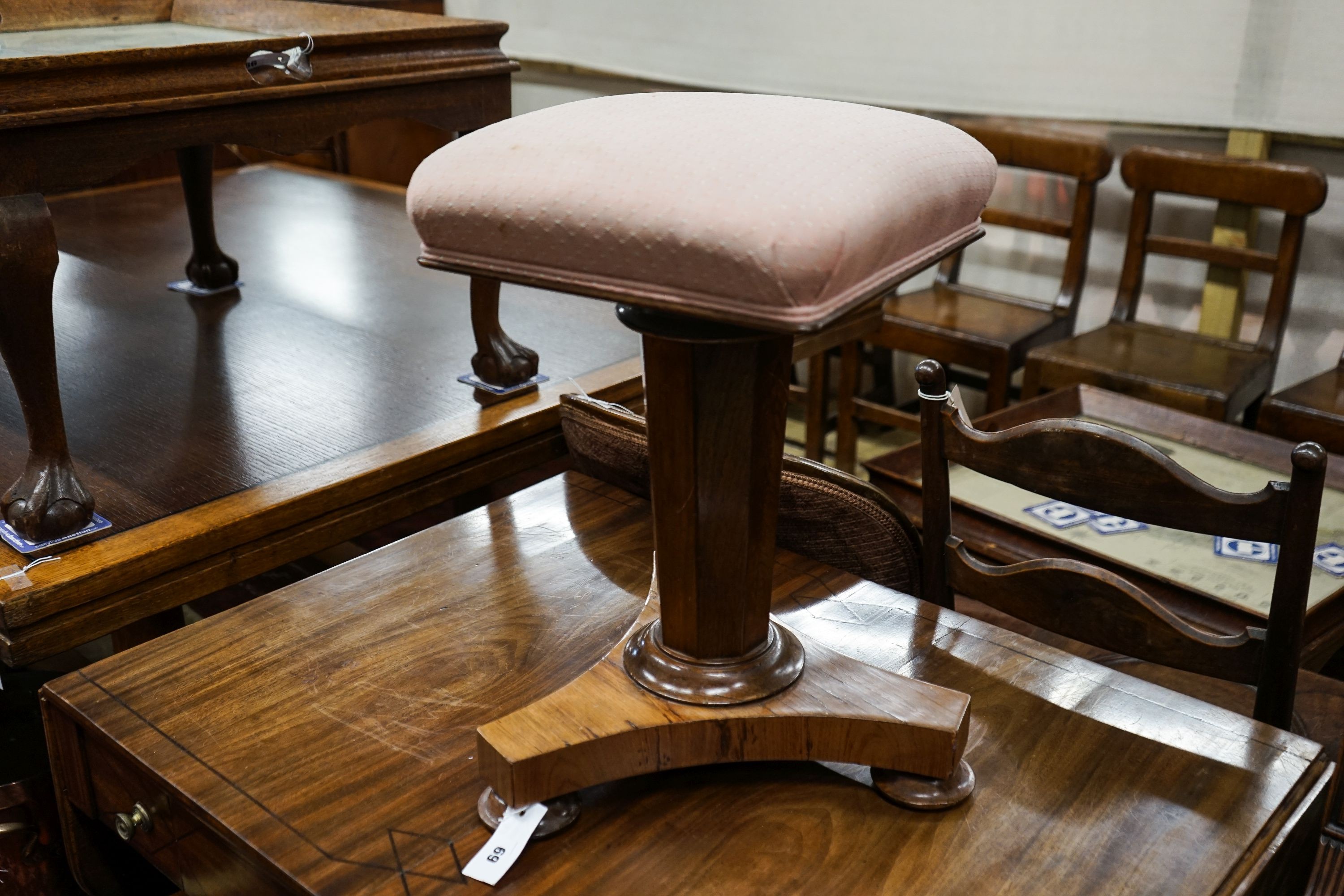 A Victorian faded rosewood adjustable piano stool